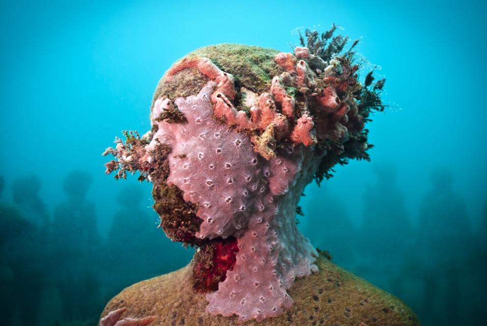 Jason deCaires Taylor's underwater statue covered with coral
